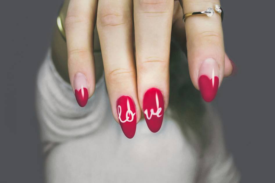 Creative nail art workspace with stencils and polish bottles